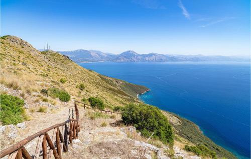 a wooden fence on a hill next to a body of water at La Casa Sul Lago in Cicerale