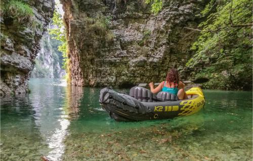 a woman in a raft in the water near a waterfall at La Casa Sul Lago in Cicerale
