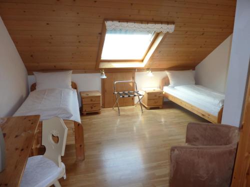 a room with two beds and a table and a window at Airport-Hotel Fortuna in Lautzenhausen