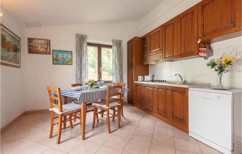 a kitchen with a table and chairs and a sink at Nice Apartment In Pieve Di Santa Luce in Pieve di Santa Luce