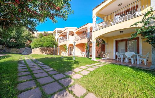 a house with a patio and a grass yard at Bilo 4 in Badesi
