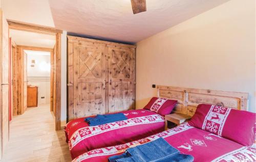 a bedroom with two beds and a wooden wall at Mont Blanc 4810 in Aosta