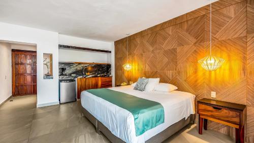 a bedroom with a large bed and a wooden wall at Marboka Hotel & Suites in Puerto Vallarta