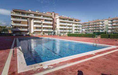a large swimming pool in front of a building at Nice Apartment In Blanes With Kitchen in Blanes