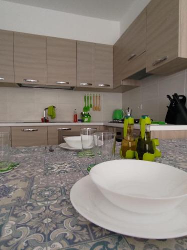 薩爾雷的住宿－Rosa dei Venti Apartment 50meter beach front，厨房配有带白板和玻璃杯的桌子