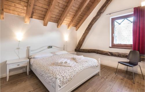 a bedroom with a white bed and a window at Fornasiero 2 in Raveo