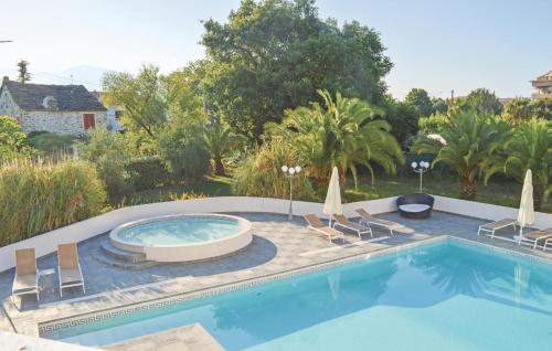 a swimming pool with lounge chairs and a swimming pool at Nice Apartment In Moriani Plage in Moriani Plage
