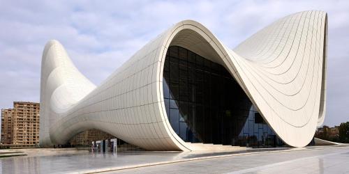 a large white building with a curved facade at MidCity Hotel in Baku