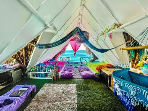 a room with a tent with beds in it at Familia Vista al Mar - Baru in Barú