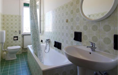 a bathroom with a sink and a toilet and a mirror at Casa Borgo 3 in Pietra Ligure