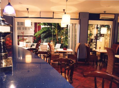 a bar in a restaurant with tables and chairs at Marina de Campios in Comillas