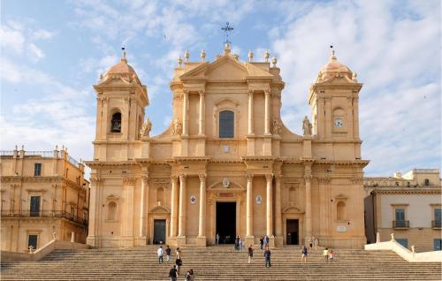a large building with stairs in front of it at Nice Home In Noto With Wifi in Noto