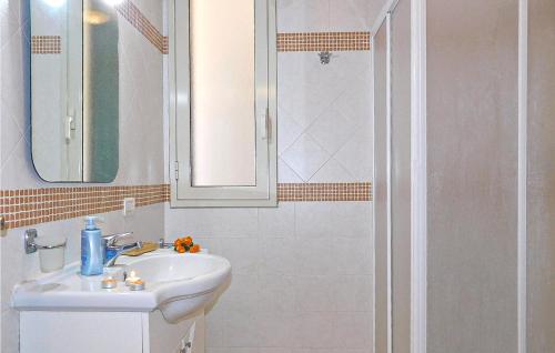 a white bathroom with a sink and a shower at Nice Home In Noto With Wifi in Noto