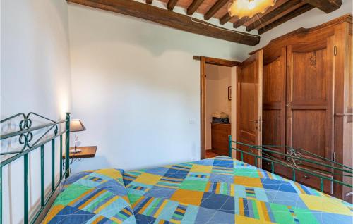 a bedroom with a bed with a colorful quilt at Le Caselle in Cortona