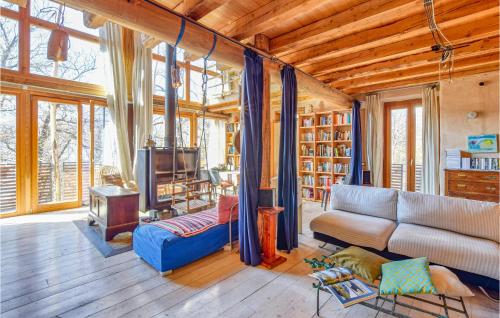a living room with a couch and a tv at 4 Bedroom Lovely Home In Cedegolo in Cedegolo
