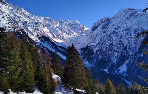 a snow covered mountain with trees in the foreground at 4 Bedroom Lovely Home In Cedegolo in Cedegolo