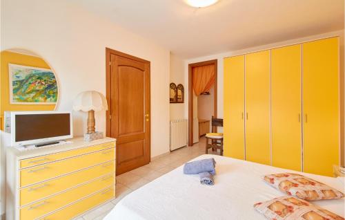 a bedroom with a bed and a tv on a dresser at Casa Flora in Dolcedo