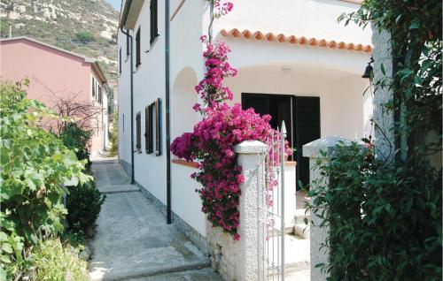 a street with flowers on a white building at Casa Virginio in Pomonte