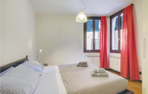 a bedroom with a large bed with red curtains at Stunning Apartment In Venezia -Ve- in Venice