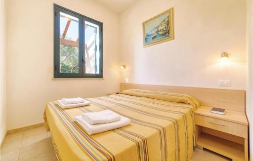 a bedroom with two beds with towels on them at Lilybeo in Case Campanella
