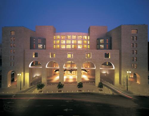 a large brick building with arches at night at The David Citadel Jerusalem in Jerusalem