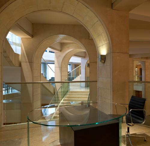 a glass table in a room with an archway at The David Citadel Jerusalem in Jerusalem