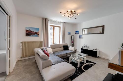 a living room with a couch and a table at Les Capucins - 3 bedroom apartment near the city in Annecy