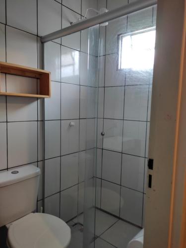 a bathroom with a toilet and a glass shower at Casa Estrela de Jorge in Sao Jorge