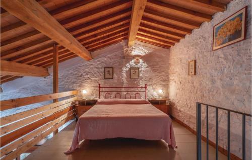 a bedroom with a bed in a stone wall at Agriturismo Segalare in Pieve Santo Stefano