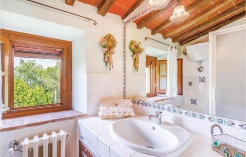 a bathroom with a sink and a mirror at Casa Al Vento Near Arezzo in Battifolle