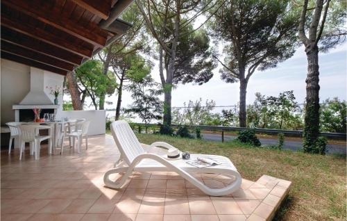 a patio with a white chair and a table at Novamiramare 2 in Belvedere