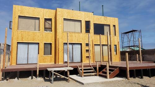 a building under construction with a wooden deck at Refugio del Archipielago D3 in Punta de Choros