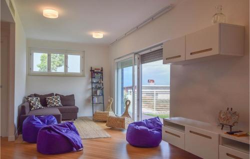 a living room with purple pillows and a couch at Villetta Il Mirto in Belladonna