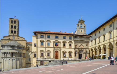 a large building with a clock tower and a cathedral at 2 Bedroom Gorgeous Home In Capolona in Capolona