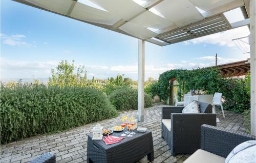 a patio with chairs and tables under a pergola at Beautiful Home In Lajatico -Pi- in Laiatico