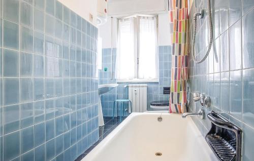 a blue tiled bathroom with a white bath tub at Lovely Apartment In Rapallo Ge in Santʼ Anna