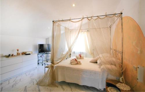 a bedroom with a canopy bed with pillows on it at Beautiful Home In Codena With Jacuzzi in Carrara