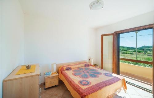 a bedroom with a bed and a desk and a window at Lotar in Castelsardo