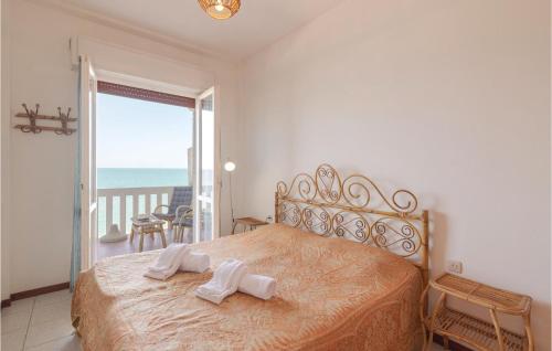 a bedroom with a bed and a balcony with the ocean at Le Vele in Marotta