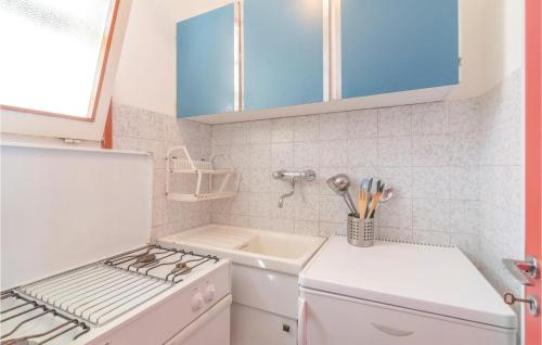 a small kitchen with a stove and a sink at Le Vele in Marotta