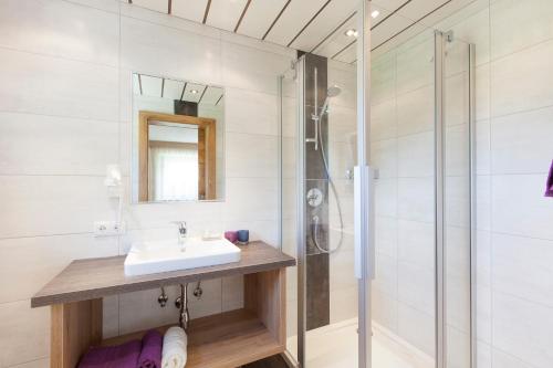 a bathroom with a sink and a shower at Lehnhof in Längenfeld