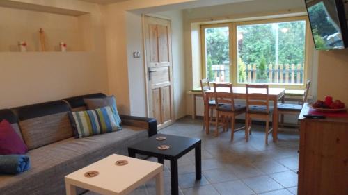 a living room with a couch and a table at Villa Karola Stryi in Wisła