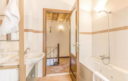 a white bathroom with a tub and a sink at Casale Orsini in Magliano Sabina