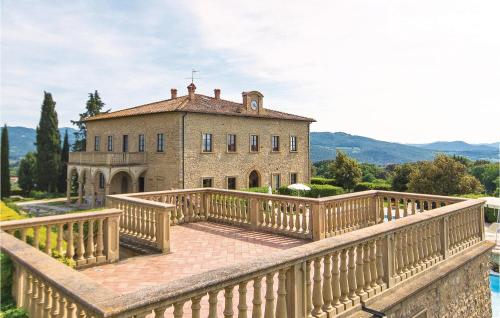 a large stone house with a wooden bridge in front of it at Corneto 4 in Pomarance