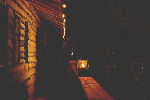 a lantern sitting on a bench next to a building at Entre Lemoine et l'arbre in Val-dʼOr