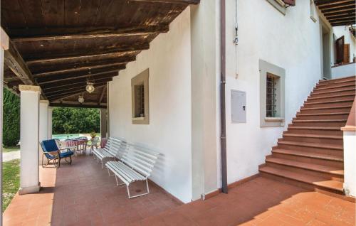 a patio with two benches and a stair case at Villa Sangelo in Collescipoli