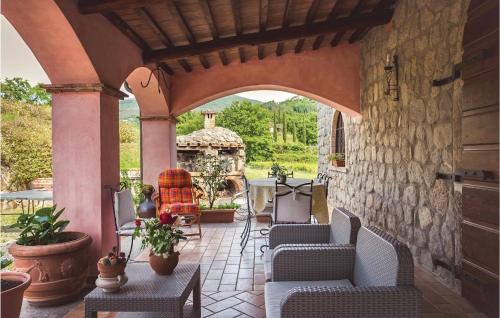 an outdoor patio with chairs and a table and a stone wall at Casale S Giacomo in Castel del Piano