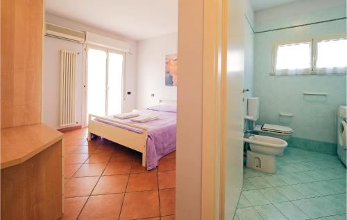 a bedroom with a bed and a bathroom with a toilet at Orizzonte 2 in Lido di Dante
