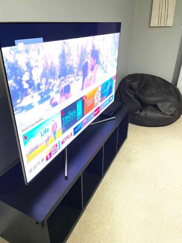 a flat screen tv sitting on top of a table at Allen Luxury Apartment in Coventry