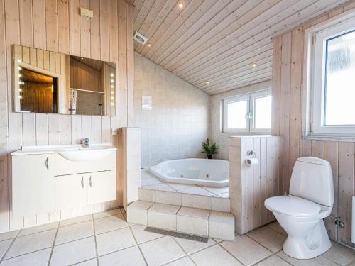 y baño con bañera, aseo y lavamanos. en Holiday home Hvide Sande LXXII, en Hvide Sande